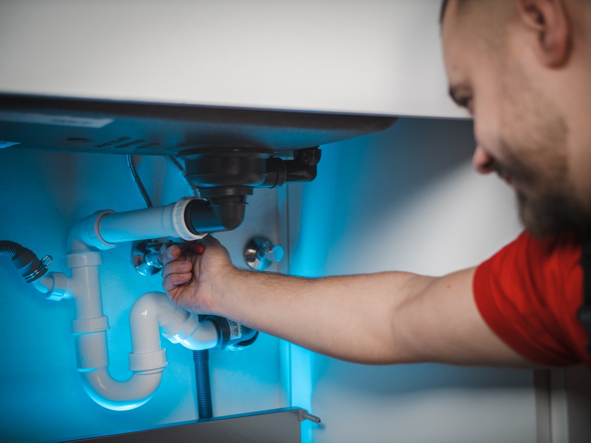 Plumber working in a home